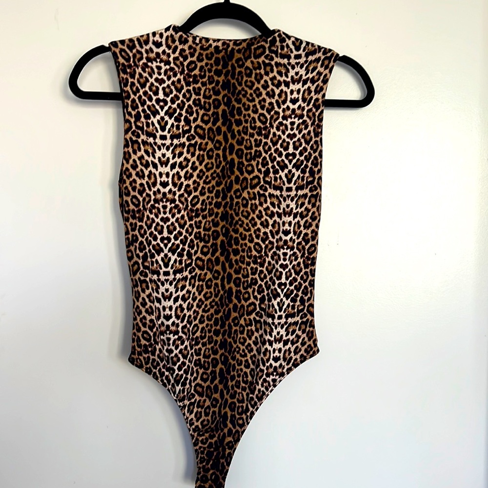Naked wardrobe sleeveless leopard bodysuit.